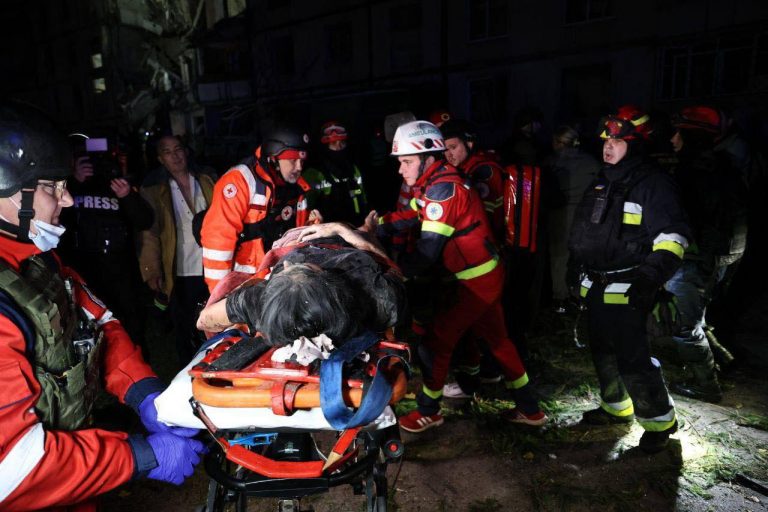 A nighttime air strike has destroyed the entrance of a multi-storey residential building in Kharkiv